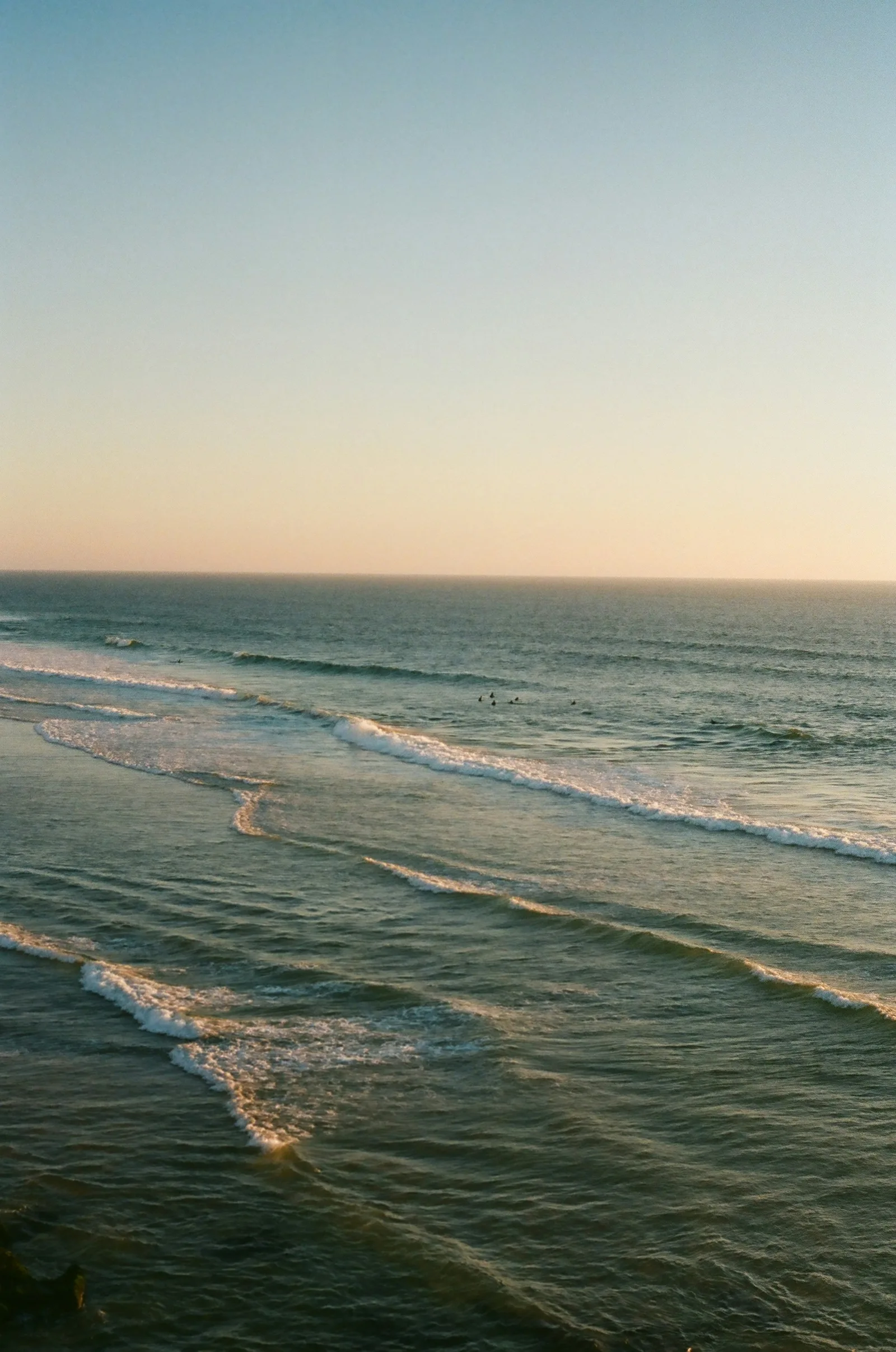 Waves catching soft light along a quiet shore